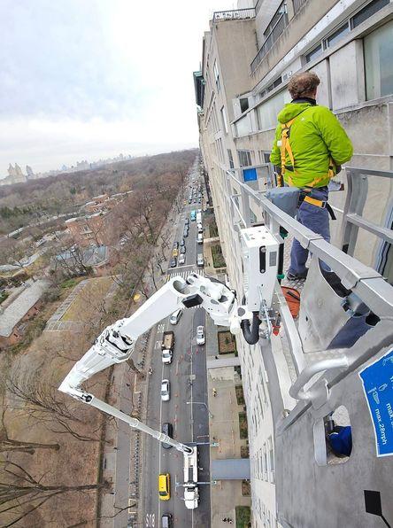 Where should the tip or platform of the aerial device be placed when rescuing victims from a window?